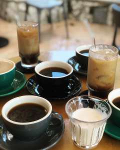 An Array of coffee drinks on the cafe table. Photo via Common Ground.