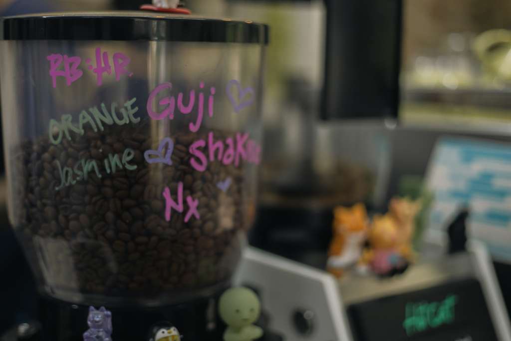 Beans sitting idle in a coffee grinder in an aesthetic coffee shop