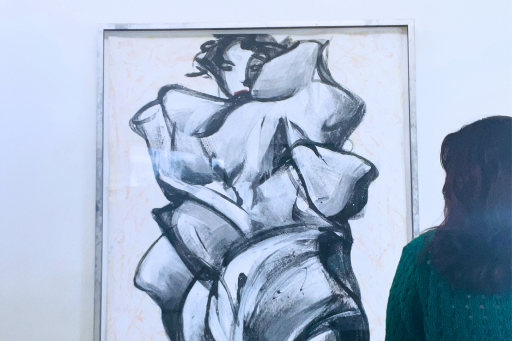 Woman admiring a BenCab painting