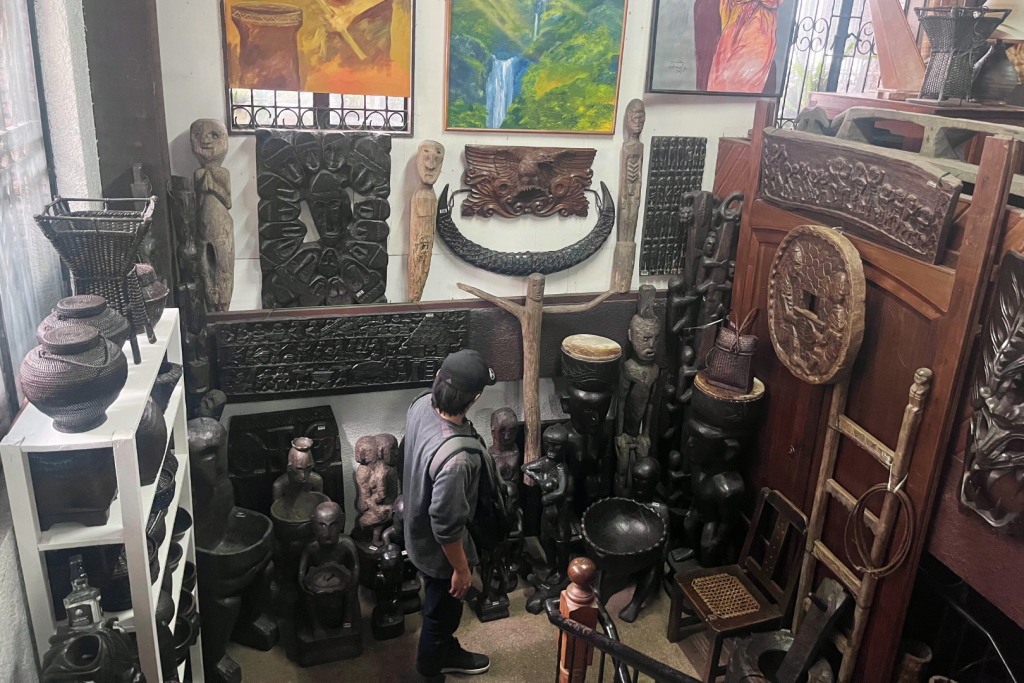 Man admiring Cordilleran wood antiques